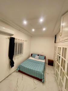 Ένα ή περισσότερα κρεβάτια σε δωμάτιο στο Appartement spacieux tout confort