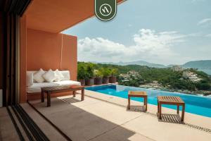 a hotel room with a bed and a swimming pool at 4 BR Penthouse - Breathtaking Views - Private Pool in Ixtapa
