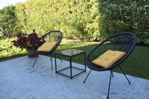two chairs and a glass table on a patio at Tenuta Tommasi - Relais Bacco in Caorle