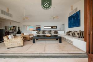 a living room with a couch and a table at 4 BR Penthouse - Breathtaking Views - Private Pool in Ixtapa