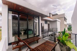a balcony of a house with a bench at Villa Richard 5mins to Seseh Beach in Munggu