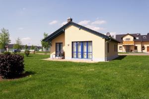 a small house in a field of green grass at Holiday home in Markkleeberg near a lake in Markkleeberg