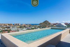 a swimming pool on the roof of a building at Amazing Studio with Rooftop Pool - 5 min to Marina in Los Médanos Partidos