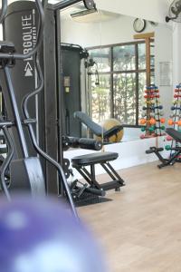 einen Fitnessraum mit Laufband und Stühlen in der Unterkunft Quality Suites Vila Olimpia in São Paulo