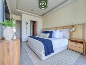 a bedroom with a large bed with blue and white pillows at Luxury Oceanfront 3 BR Condo with Balcony in Cruz de Huanacaxtle +55 photos