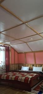 a bedroom with a large bed with red walls at Welcome homestay in Pemayangtse