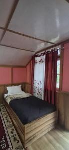 a small bed in a room with a window at Welcome homestay in Pemayangtse +2 photos