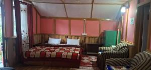 a small bedroom with a bed and two chairs at Welcome homestay in Pemayangtse