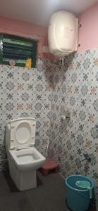 a bathroom with a white toilet in a room at Welcome homestay in Pemayangtse