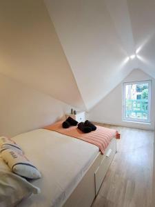 a bedroom with a large bed in a attic at Cosy Villa by sea ! - two terraces in Ouistreham