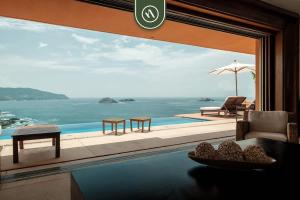 a living room with a view of the ocean at 4 BR Penthouse - Breathtaking Views - Private Pool in Ixtapa