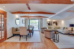 a living room with white walls and wooden ceilings at Slack Tide On Duval Street in Key West
