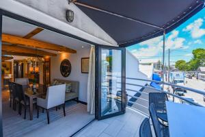 a balcony with a table and chairs on a balcony at Slack Tide On Duval Street in Key West