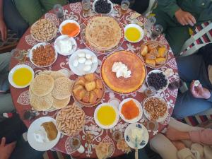 a table topped with lots of food and drinks at Gite Ain Bechar in Taza