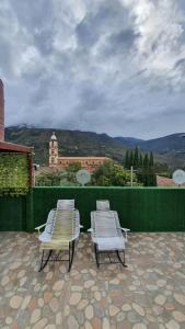 two white chairs sitting on top of a patio at hotel Mountain Dream Resort El Cocuy in El Cocuy