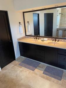 a bathroom with two sinks and a large mirror at Tortuga Bay TBB 2502 in San José del Cabo