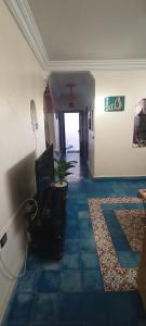 a hallway with a living room with a table and a television at Dar Mobarak in Oualidia +6 photos