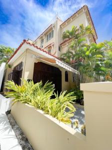 a white house with plants in front of it at Canario Boutique Hotel in San Juan
