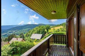 a balcony with a view of the mountains at Chalet SOL LA MI in Soultzeren