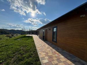 a building with a brick walkway next to it at Holiday House Adamo in Selno