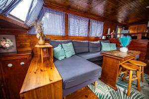 a living room with a blue couch in a cabin at Prague Bay Houseboats in Prague +43 photos