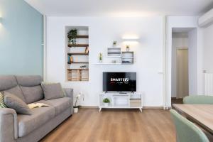 a living room with a couch and a tv at NEW Luxury Flat 10min P Nuova in Turin