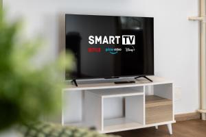 a flat screen tv sitting on a white entertainment center at NEW Luxury Flat 10min P Nuova in Turin