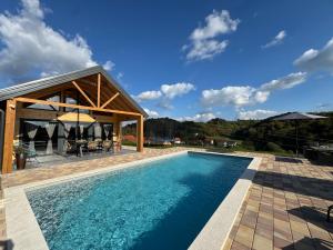 a swimming pool in front of a house at Holiday House Adamo in Selno
