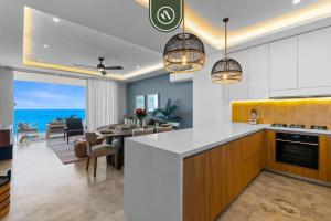 a kitchen and dining room with a view of the ocean at New Stylish 1 BR Condo - Ocean Views - Flex Room in Bucerías