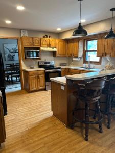 a kitchen with wooden cabinets and a island with a counter top at Backyard Bliss in Wichita