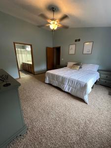 a bedroom with a bed and a ceiling fan at Backyard Bliss in Wichita