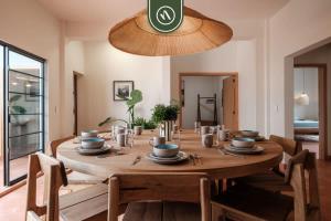 a wooden table in a dining room with a tableablish at Centric 3BR Condo in Downtown in Oaxaca in Oaxaca City