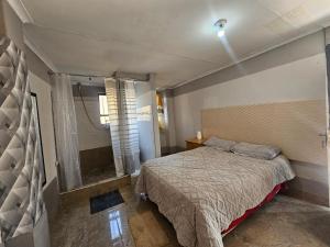 a small bedroom with a bed and a window at TURFLOOP guest house in Mankweng