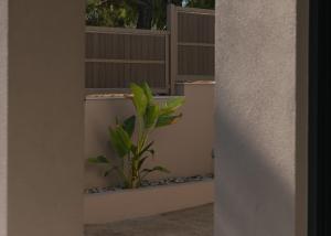 a plant on a wall next to a fence at Amelia Residence in Tragaki