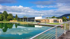a large building next to a body of water at Hardi's Hotel in Inzell
