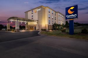 a hotel with a sign in front of a building at Comfort Inn & Suites Fort Smith I-540 in Fort Smith