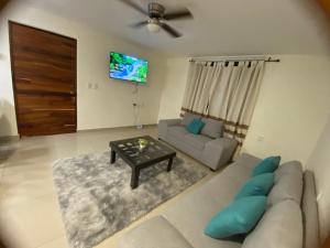 a living room with a couch and a table at Newly remodeled apartment in Huatulco in Santa Cruz Huatulco