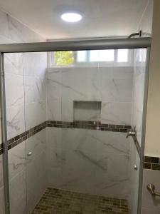 a shower with a glass door in a bathroom at Newly remodeled apartment in Huatulco in Santa Cruz Huatulco