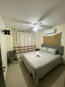 a bedroom with a bed with a ceiling fan at Newly remodeled apartment in Huatulco in Santa Cruz Huatulco