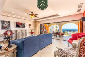 a living room with a blue couch and a table at 2BR Condo with Private Terrace - Ocean View - Pool in El Tule