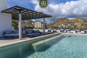 a swimming pool with chairs and a gazebo at Amazing Studio with Rooftop Pool - 5 min to Marina in Los Médanos Partidos