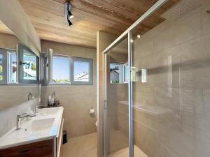a bathroom with a shower and a sink and a toilet at The Gathering Lodge - Crans Montana - Swiss Alps in Lens +17 photos