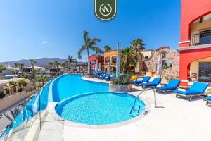 a swimming pool at a resort with blue lounge chairs at Amazing House with Private Terrace - Private Pool in El Tule