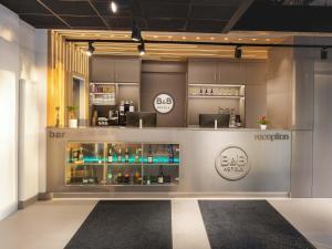 a showroom with a bar and a kitchen at B&B HOTEL Berlin Airport-Nord in Berlin +18 photos