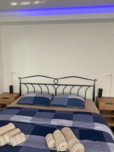 a bed with blue and white sheets and towels on it at Wellness Varaždin in Varaždin