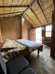 a bedroom with a large bed in a room at Hameri Homestay in Belparāo