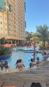 a group of people in a swimming pool at a hotel at Enjoy Olímpia Park Resort in Olímpia