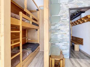 two bunk beds in a room with a brick wall at Résidence Lac du Lou - Les Ménuires in Les Menuires +4 photos