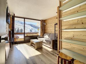 a room with a bed and a couch in a room at Résidence Lac du Lou - Les Ménuires in Les Menuires