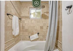 a bath tub in a bathroom with a window at Beachfront Condo with Amazing View to the Sea in El Tule +26 photos